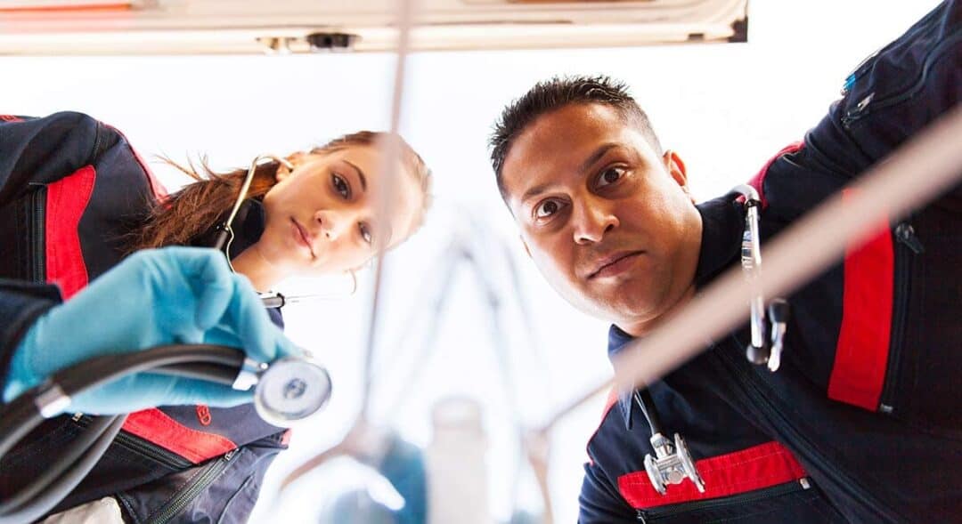 Ambulance team looking over anaphylactic emergency. View from patient perspective
