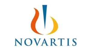 Logo of Novartis featuring a stylized orange and yellow flame design with a vertical blue element at the center above the brand name "Novartis" in blue capital letters.