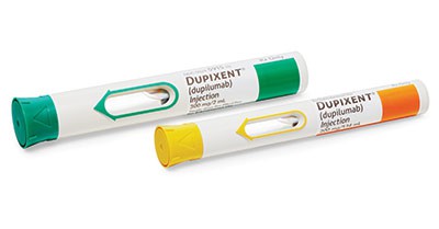 Two Dupixent (dupilumab) injection pens are shown. One has a green cap and the other has a yellow cap. Both pens are white with labels indicating the medication and dosage information.