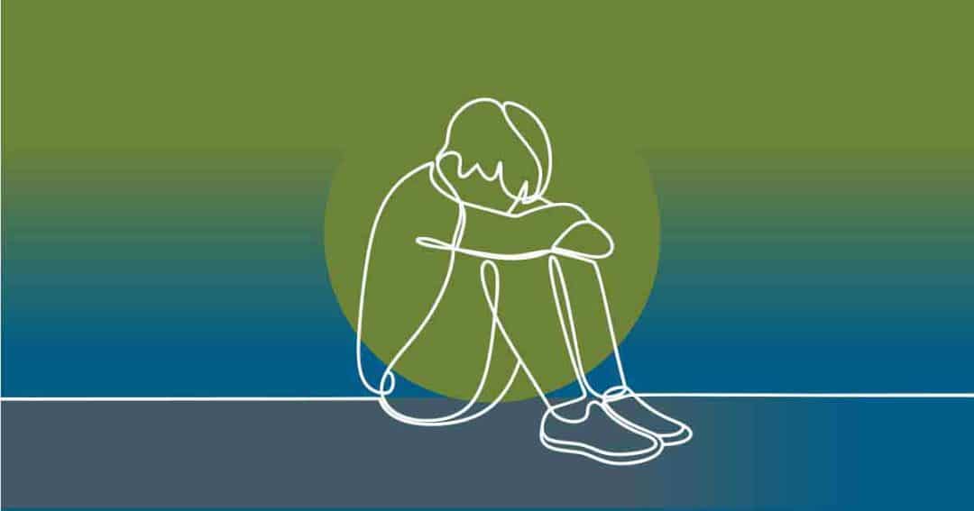 A simple line drawing of a person sitting on the ground with knees pulled to their chest and head resting on their arms, against a gradient green and blue background, conveying a sense of sadness or loneliness.